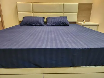 a large bed with purple sheets in a bedroom at Gated Family House- next to MRSM in Kampong Kawak