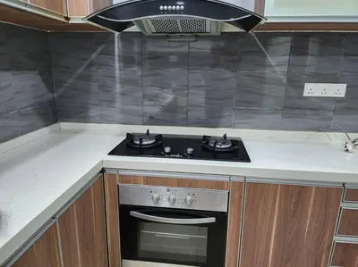 a kitchen with a stove top oven in a kitchen at Gated Family House- next to MRSM in Kampong Kawak