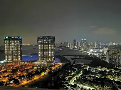 a city skyline at night with tall buildings at LM HomeyB 3BR Coastline Family Suite for 4-14 Pax with Nexflix & Coway Water Purifier in Tanjong Tokong