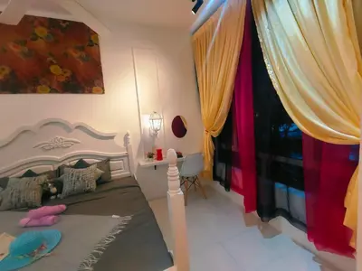 a bedroom with a bed and a window with curtains at SKGARDEN HOME A1 BY IRAINBOW in Ipoh