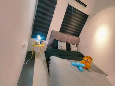 a bedroom with a bed with a teddy bear sitting on it at SKGARDEN HOME A1 BY IRAINBOW in Ipoh