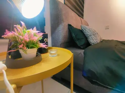 a living room with a couch and a table with plants at SKGARDEN HOME A1 BY IRAINBOW in Ipoh