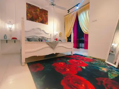 a bedroom with a bed with flowers on the floor at SKGARDEN HOME A1 BY IRAINBOW in Ipoh