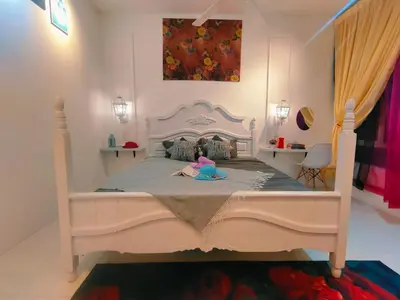 a little girl sitting on a bed in a bedroom at SKGARDEN HOME A1 BY IRAINBOW in Ipoh
