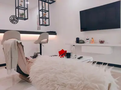 a white living room with a table and a white blanket at C Boutique Townhouse Station 18 Ipoh By irainbow in Ipoh