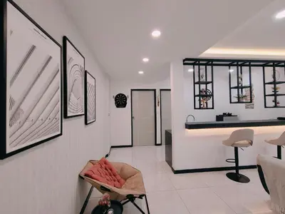 a living room with a chair and a counter at C Boutique Townhouse Station 18 Ipoh By irainbow in Ipoh