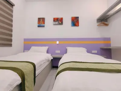 two beds sitting next to each other in a room at C Boutique Townhouse Station 18 Ipoh By irainbow in Ipoh