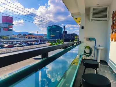 a swimming pool in a building with a view of a city at C Boutique Townhouse Station 18 Ipoh By irainbow in Ipoh