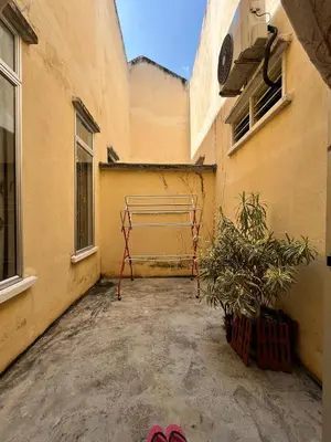 a courtyard with a metal rack on the side of a building at Rumah Tamu by Perdana Hōmes for Múslim only in Sungai Petani