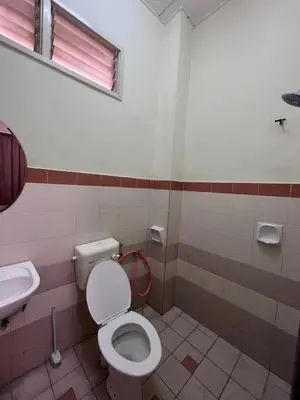 a bathroom with a toilet and a sink at Rumah Tamu by Perdana Hōmes for Múslim only in Sungai Petani