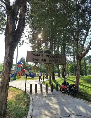 a sign for a park with a motorcycle parked next to it at Rumah Tamu by Perdana Hōmes for Múslim only in Sungai Petani