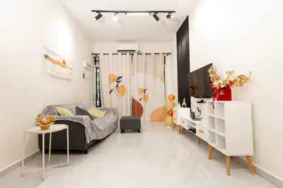 a living room with a bed and a tv at Taiping Aulong [3 rooms] nearby TF Mart/Econsave in Taiping