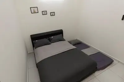 a bed in a room with two pillows on it at Taiping Aulong [3 rooms] nearby TF Mart/Econsave in Taiping