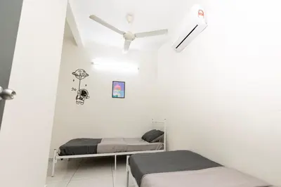 two beds in a white room with a ceiling fan at Taiping Aulong [3 rooms] nearby TF Mart/Econsave in Taiping