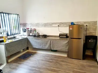 a kitchen with a counter and a refrigerator at (TS) Cozy House 4 Room10Pax@ALMA in Bukit Mertajam