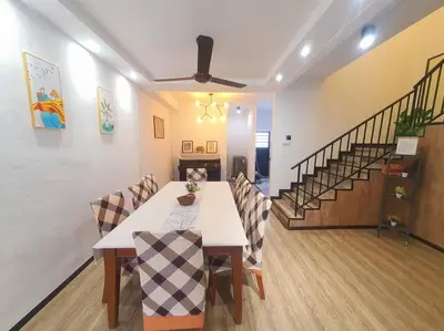 a dining room with a table and chairs and a staircase at (TS) Cozy House 4 Room10Pax@ALMA in Bukit Mertajam