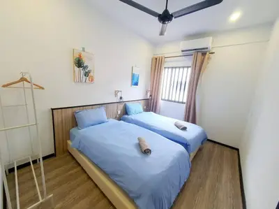 two beds sitting next to each other in a room at (TS) Cozy House 4 Room10Pax@ALMA in Bukit Mertajam