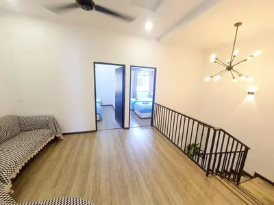 a living room with a couch and a ceiling fan at (TS) Cozy House 4 Room10Pax@ALMA in Bukit Mertajam