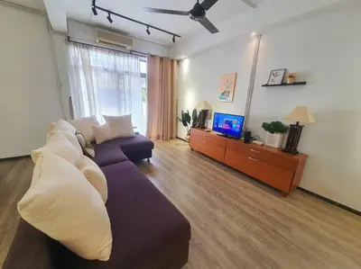 a living room with a couch and a tv at (TS) Cozy House 4 Room10Pax@ALMA in Bukit Mertajam