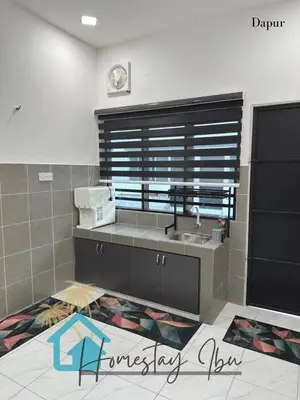 a kitchen with a sink and a window at Homestay Ibu in Lumut