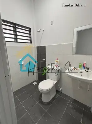 a bathroom with a toilet and a sink at Homestay Ibu in Lumut