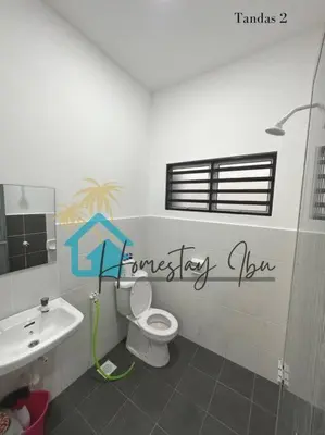 a bathroom with a toilet and a sink at Homestay Ibu in Lumut