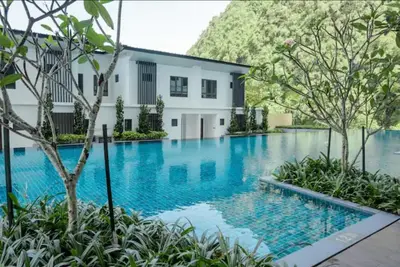 a swimming pool in front of a house at Onsen Premium Hotspring Suite Sunway Tambun Ipoh in Tambun