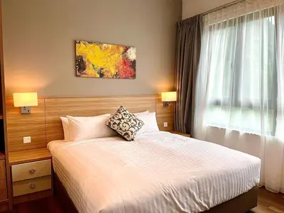 a bedroom with a bed with two pillows on it at Onsen Premium Hotspring Suite Sunway Tambun Ipoh in Tambun