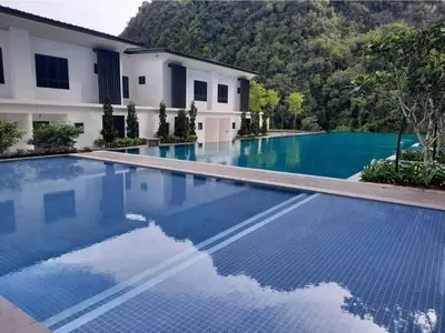 an empty swimming pool in front of a house at Onsen Premium Hotspring Suite Sunway Tambun Ipoh in Tambun
