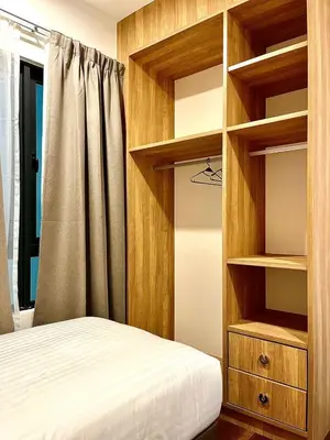 a bedroom with wooden shelves and a bed at Onsen Premium Hotspring Suite Sunway Tambun Ipoh in Tambun