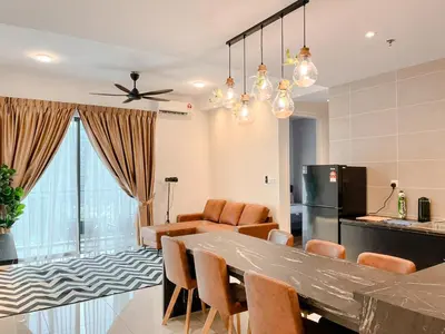 a kitchen and living room with a table and chairs at Onsen Premium Hotspring Suite Sunway Tambun Ipoh in Tambun