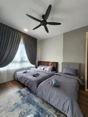 a bedroom with two beds and a ceiling fan at Sunway onsen suite ipoh in Ipoh
