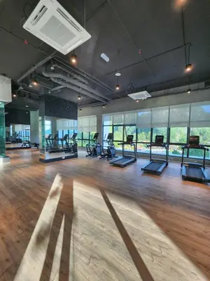 a gym with a lot of treadmills and ellipticals at Sunway onsen suite ipoh in Ipoh