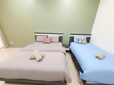 two beds sitting next to each other in a bedroom at MODERN STYLISH 2STOREY HOUSE 8PAX@ALMA NEAR JUSCO in Bukit Mertajam