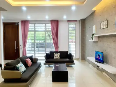 a living room with two couches and a tv at MODERN STYLISH 2STOREY HOUSE 8PAX@ALMA NEAR JUSCO in Bukit Mertajam