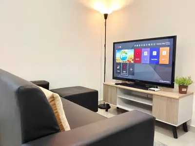 a living room with a flat screen tv on a table at \u3010NEW\u3011Modern Comfort Studio@Juru Sentral Icon City in Bukit Mertajam