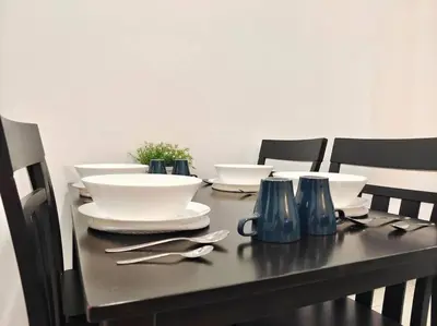 a table with plates and utensils on it at \u3010NEW\u3011Modern Comfort Studio@Juru Sentral Icon City in Bukit Mertajam