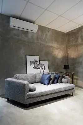 a couch with blue pillows in a room at M-Stay Hostel in Chemor
