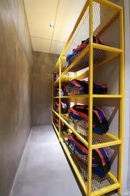 a room with a yellow rack withidasidasamentsamentsaments at M-Stay Hostel in Chemor
