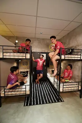 a group of people standing on top of bunk beds at M-Stay Hostel in Chemor