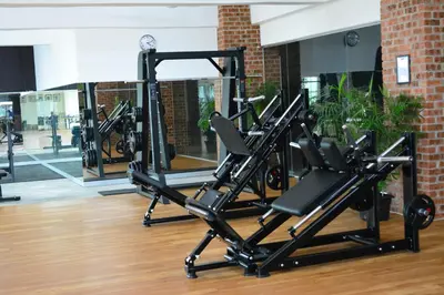 a gym with several tread machines in a room at M-Stay Hostel in Chemor