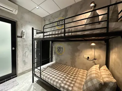 a bedroom with two bunk beds and a tv at M-Stay Hostel in Chemor