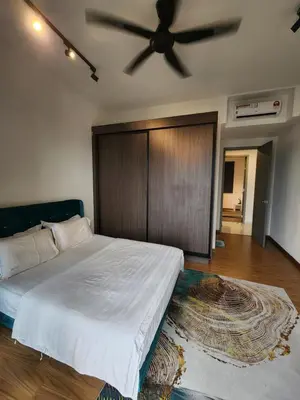 a bedroom with a large bed with a ceiling fan at Beacon Executive Suite - Skypool Penang View in George Town
