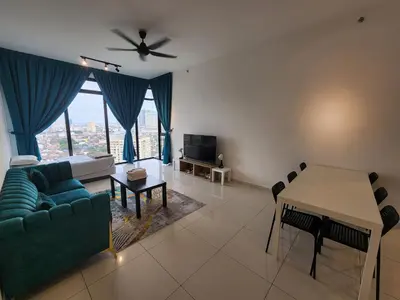 a living room with a couch and a table at Beacon Executive Suite - Skypool Penang View in George Town
