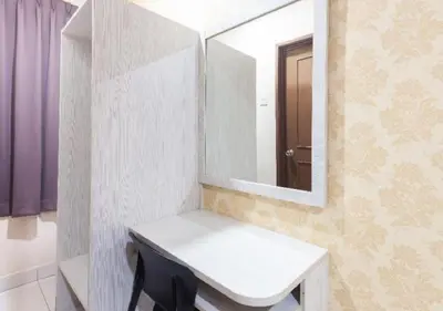 a bathroom with a white sink and a mirror at Hotel Pulai Ipoh in Ipoh