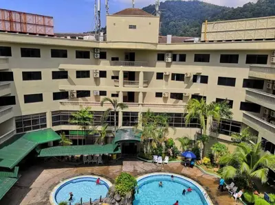 an apartment building with two pools in front of it at Affordable Cozy Apartment @ Coral Bay Resort in Pasir Bogak