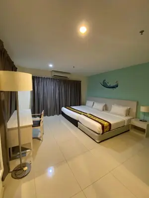 a bedroom with a large bed and a lamp in it at AnyLodge Waterfront Marina Island Pangkor-Lumut in Lumut
