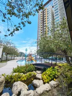 a garden with a bridge over a pond in a city at Ipoh D Festivo Suites 6-10pax 10mins to Sunway Tambun by IWH in Ipoh