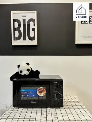 a stuffed panda bear sitting on top of a microwave at Ipoh D Festivo Suites 6-10pax 10mins to Sunway Tambun by IWH in Ipoh