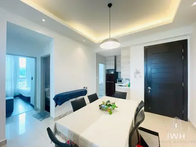 a dining room and kitchen with a white table and chairs at Ipoh D Festivo Suites 6-10pax 10mins to Sunway Tambun by IWH in Ipoh